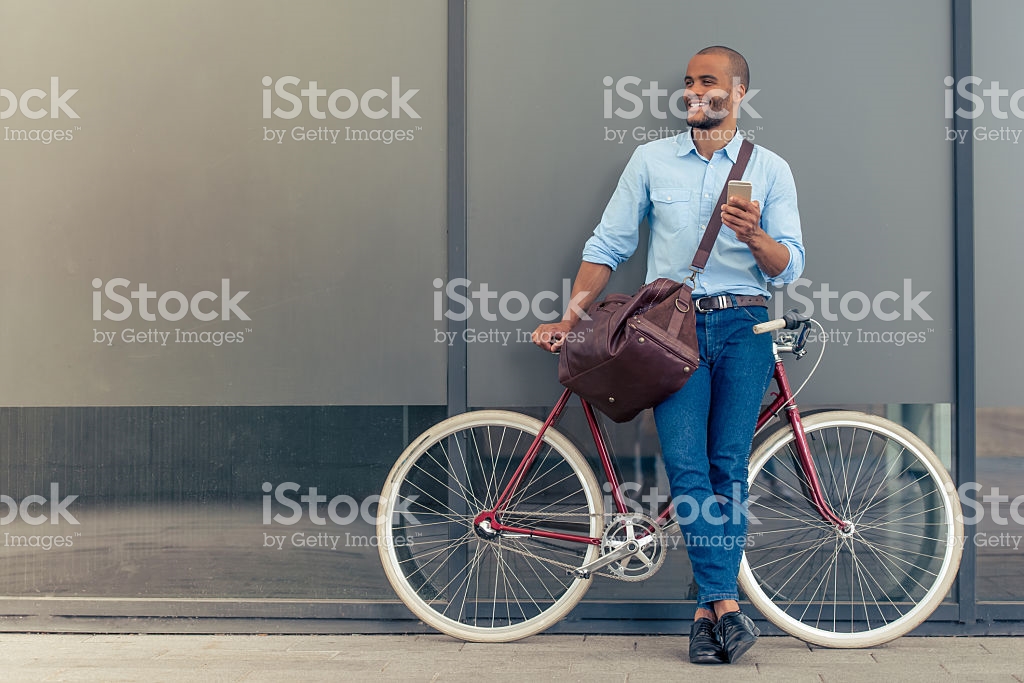 man standing with a bike