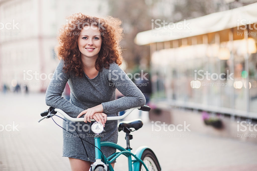 woman leaning over a bike