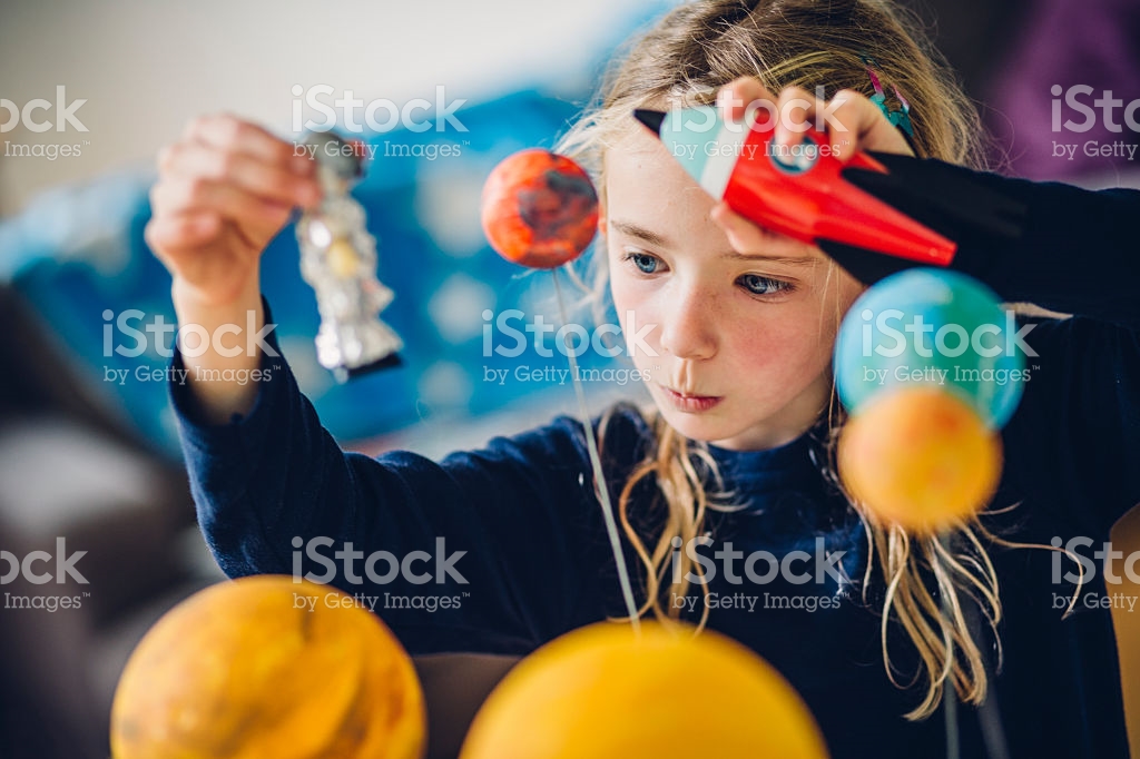 girl looking at the solar system