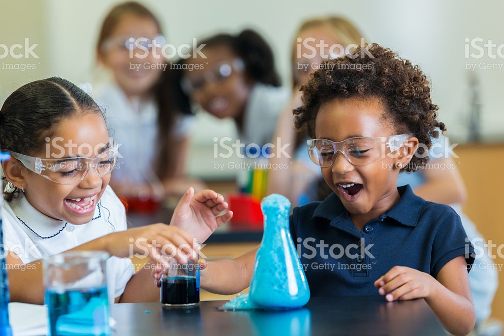 Kid girl and boy with goggles doing an experiment