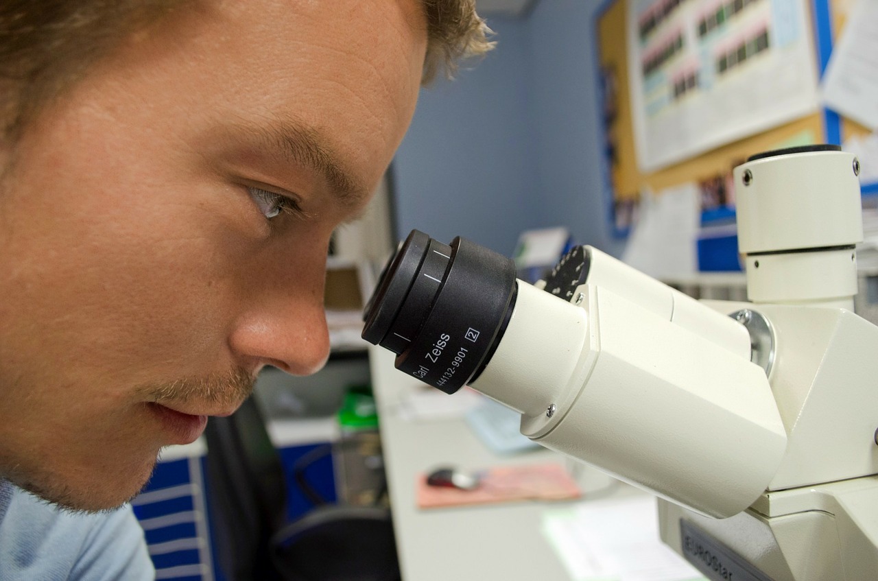 Close up of a man looking in a microscope