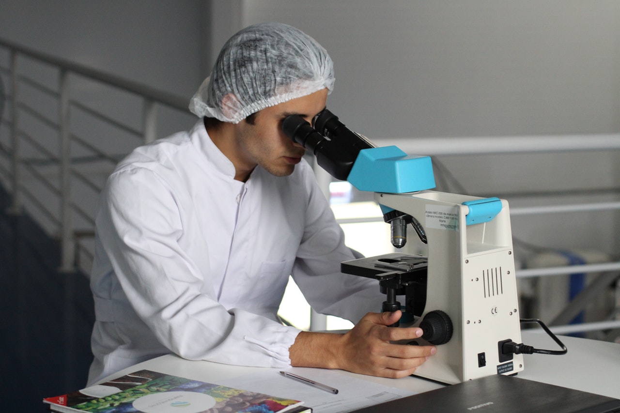 Man looking into microscope